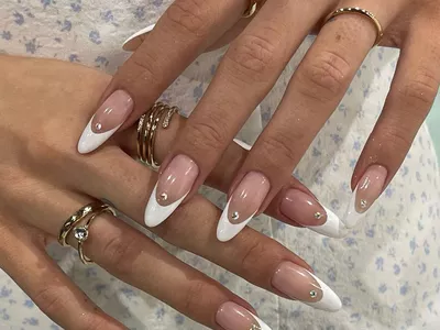 Almond-shaped nails with French manicure nail art. 