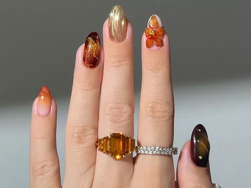 mismatched fall manicure with brown, gold, and orange designs